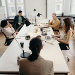 Collaborative business meeting in a modern office with diverse colleagues.